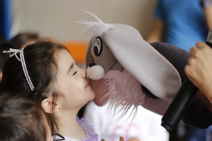 niña con personaje del show de títeres